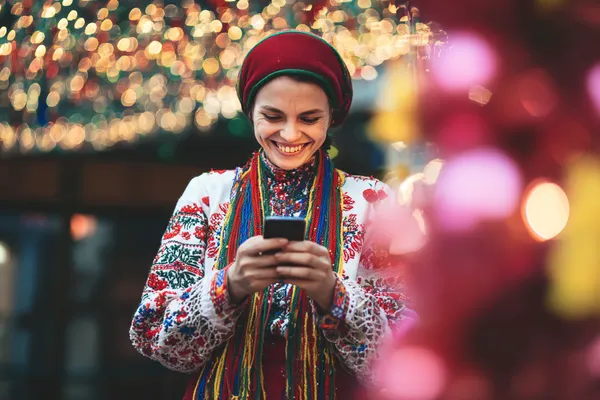A woman in a luxurious green gown next to an ornate roulette wheel, capturing the upscale casino mood of 4777BETT.