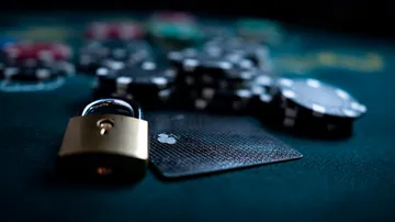A laptop glowing with a bright login prompt in a minimalistic setup, symbolizing the protected access system at 4777BETT.